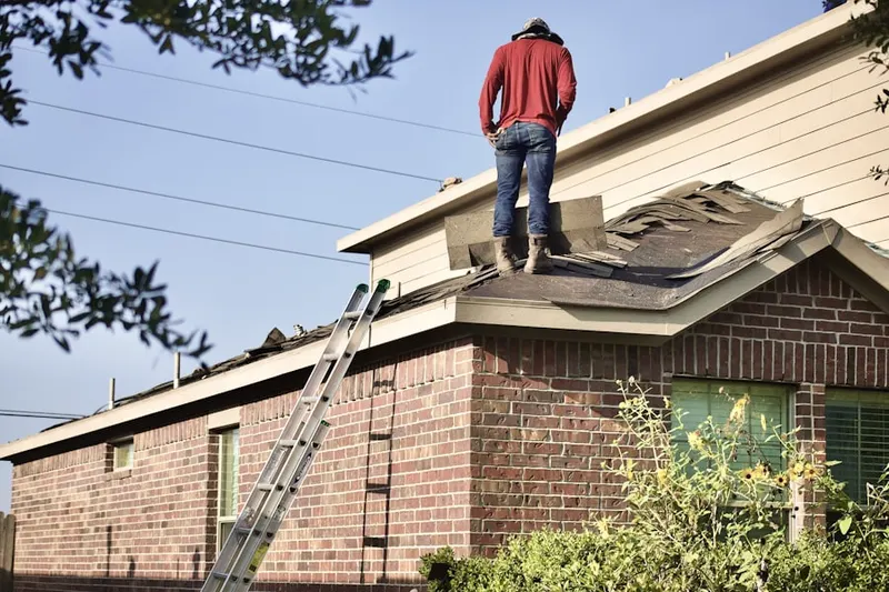 Professional roofer working on a residential roof in Flower Mound